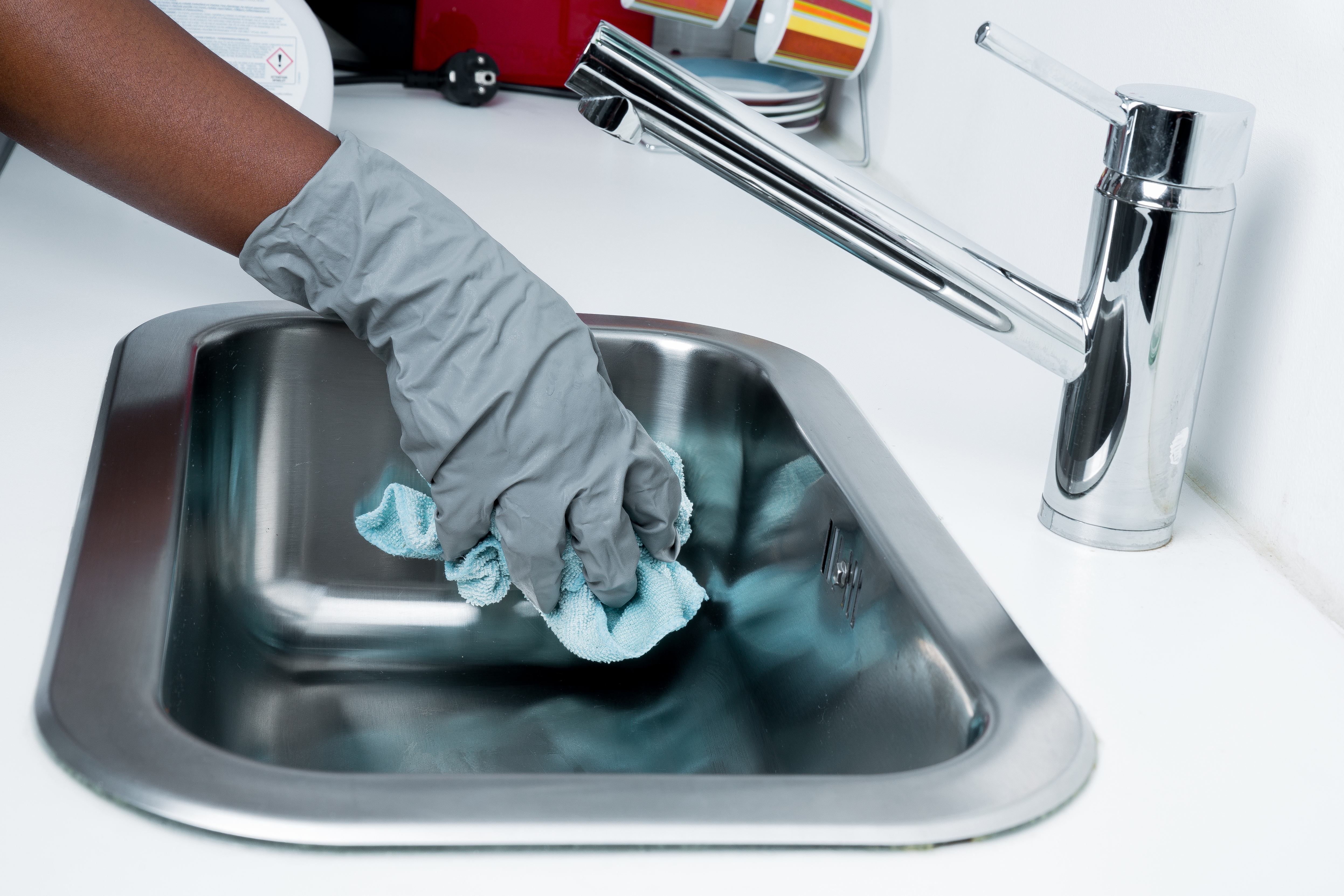 Service worker cleaning a sink