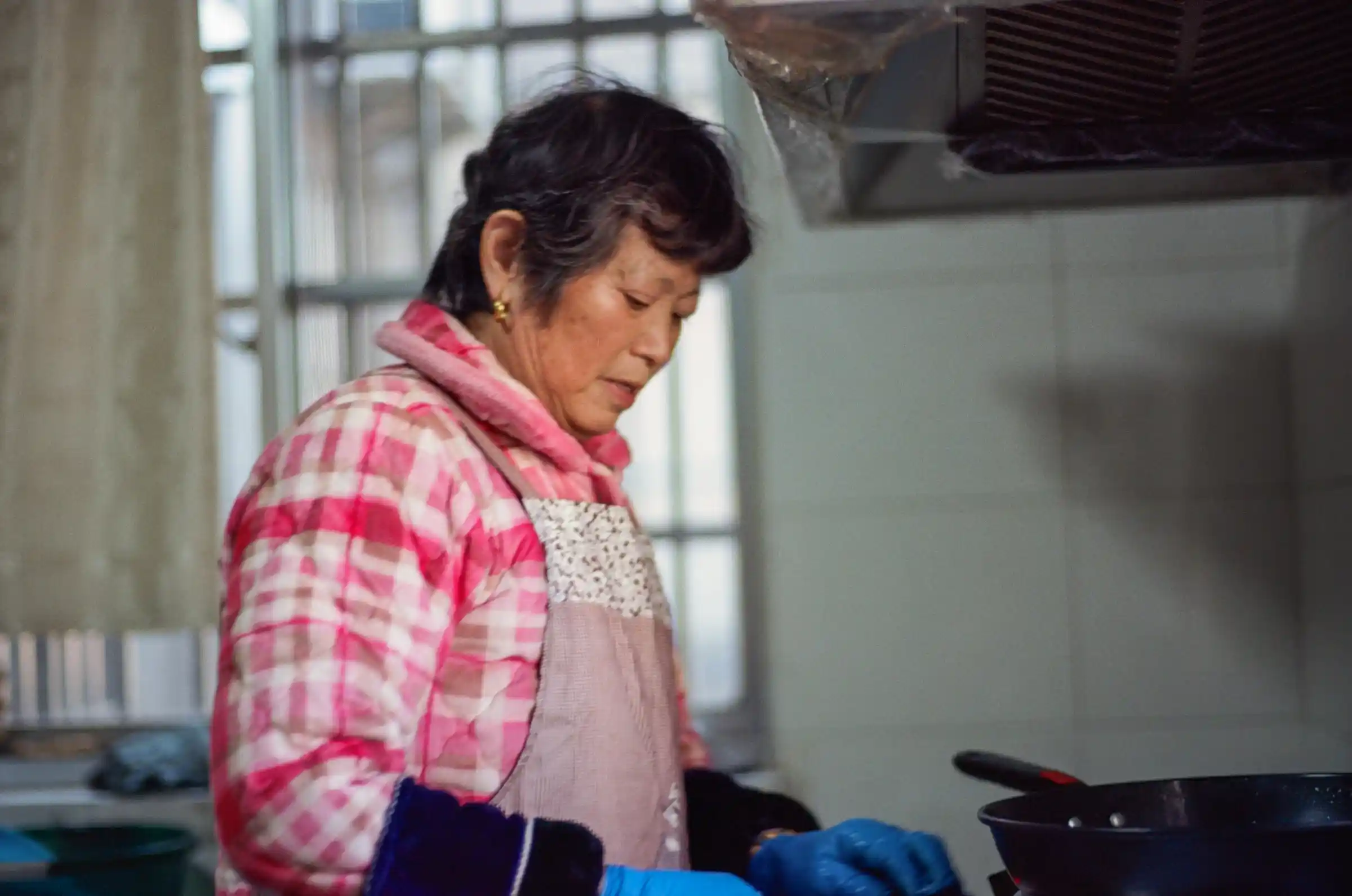 Domestic worker cooking in a UAE home kitchen
