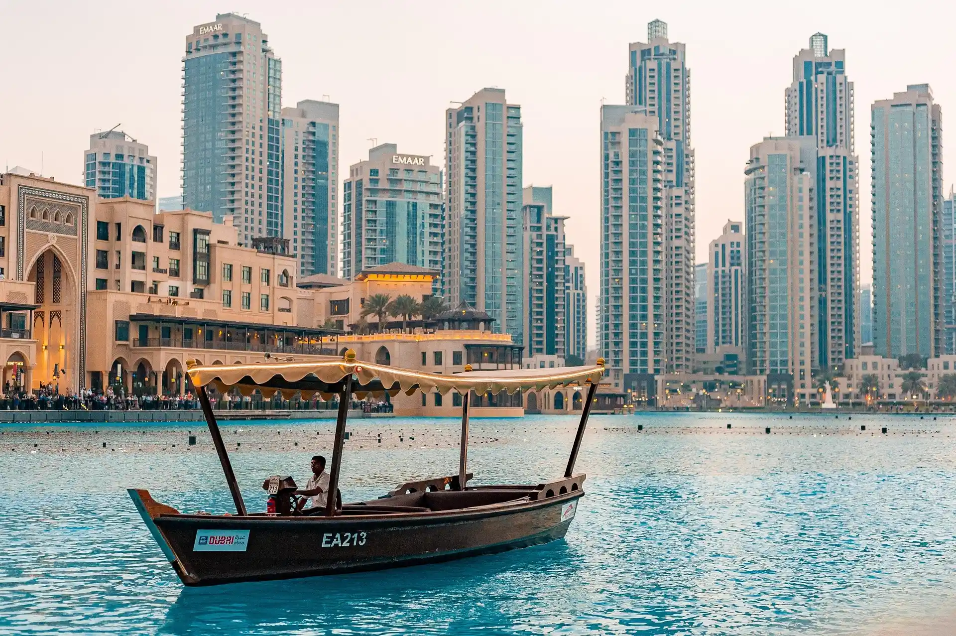 Dubai waterfront skyline with traditional boat